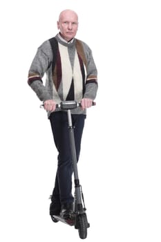 in full growth. serious mature man with electric scooter. isolated on a white background.