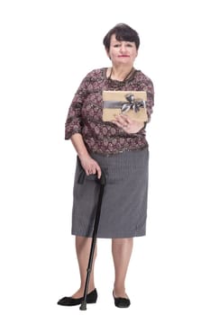 in full growth. elderly woman with a gift box. isolated on a white background.