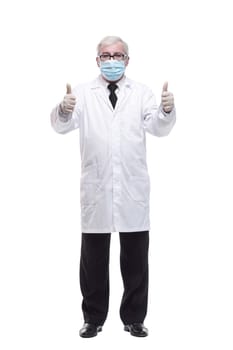 full-length. mature doctor in protective mask and gloves . isolated on a white background.