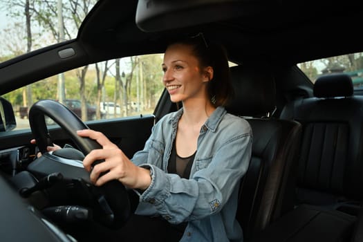 Young sportswoman driving a car during going to her training in fitness centre or gym. Healthy lifestyle, fitness lifestyle concept.