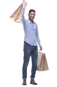 in full growth. happy man showing his purchases. isolated on a white background.