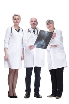 in full growth. Group of doctors looking at x-ray.isolated on white.
