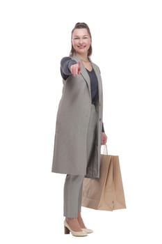 in full growth. attractive woman with a shopping bag .isolated on a white background.