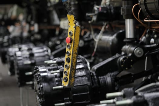 Control panel with buttons in production of car parts and engines. Concept of car repair workshop and industrial production of engines and spare parts