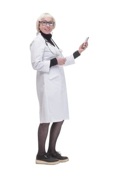 in full growth. female doctor with a smartphone. isolated on a white background.