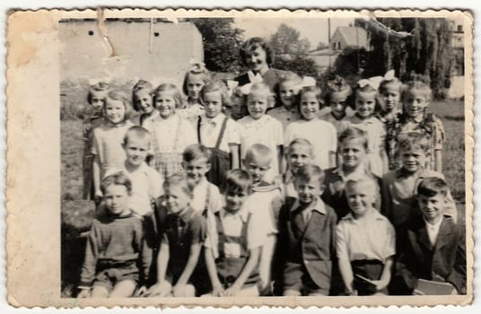 THE CZECHOSLOVAK SOCIALIST REPUBLIC - CIRCA 1948: Vintage photo shows pupils (schoolmates) and their female teacher.