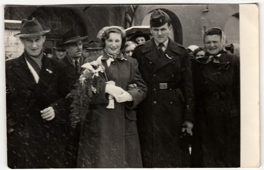 THE CZECHOSLOVAK SOCIALIST REPUBLIC - CIRCA 1960: A vintage photo shows bride and bridegroom (soldier). The wedding ceremony is in winter time.