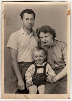 THE CZECHOSLOVAK SOCIALIST REPUBLIC - CIRCA 1960s: A vintage photo shows mother, father and their small son.