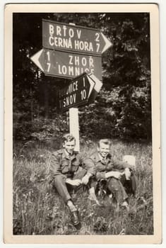 THE CZECHOSLOVAK SOCIALIST REPUBLIC - 1960s: Vintage photo shows soldiers sit at the mile stone.