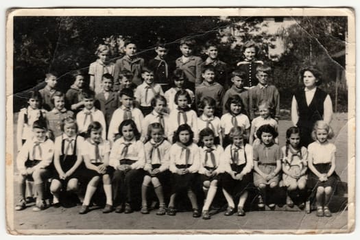 THE CZECHOSLOVAK SOCIALIST REPUBLIC - CIRCA 1948: Vintage photo shows pupils (schoolmates) and their female teacher.