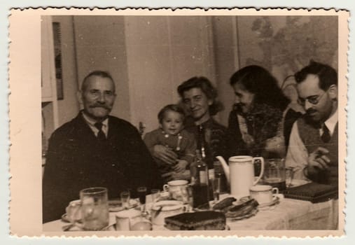 THE CZECHOSLOVAK REPUBLIC - CIRCA 1940s: Vintage photo shows family during the feast.