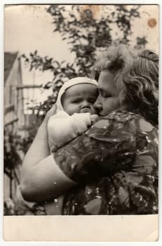 THE CZECHOSLOVAK SOCIALIST REPUBLIC - 1960s: Vintage photo shows young woman cradles baby.