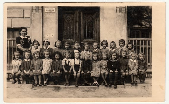 THE CZECHOSLOVAK SOCIALIST REPUBLIC - CIRCA 1948: Vintage photo shows pupils (schoolmates) and their female teacher.