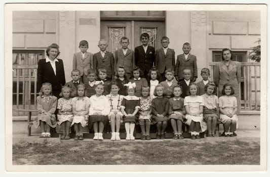 THE CZECHOSLOVAK SOCIALIST REPUBLIC - CIRCA 1948: Vintage photo shows pupils (schoolmates) and their female teacher.