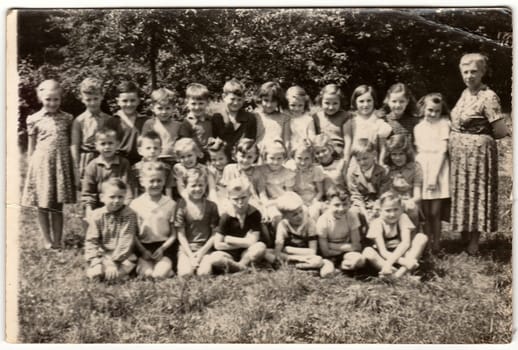 THE CZECHOSLOVAK SOCIALIST REPUBLIC - CIRCA 1960s: Vintage photo shows pupils (schoolmates) and their female teacher.