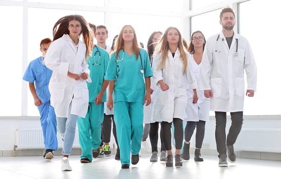 in full growth. group of hilarious doctor interns showing thumbs up