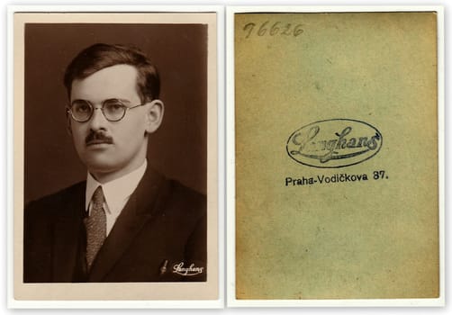 THE CZECHOSLOVAK REPUBLIC - CIRCA 1920s: Front and back of vintage photo shows young man with glasses and moustache. Antique black white photo with sepia tint