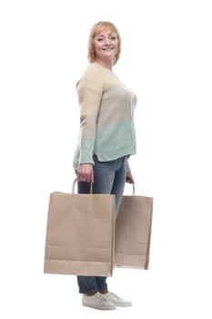 in full growth. attractive casual woman with shopping bags . isolated on a white background.
