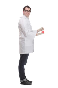 Confident man doctor wearing unifrom and glasses standing isolated over white background, holding beaker