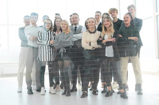 in full growth. group of diverse young people standing in the office
