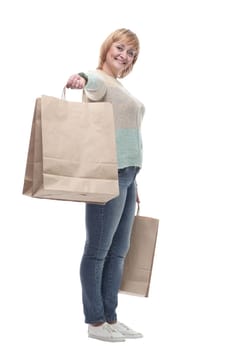 in full growth. attractive casual woman with shopping bags . isolated on a white background.