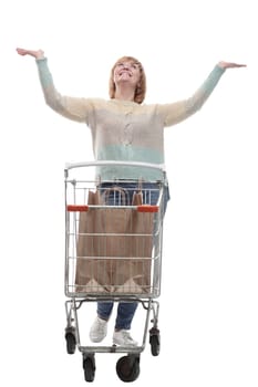 in full growth. attractive casual woman with shopping cart . isolated on a white background.