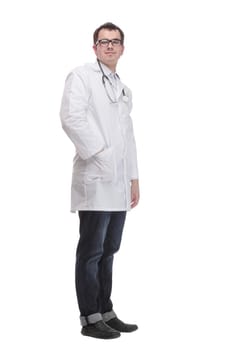 Young doctor man wearing white coat and stethoscope with smile on face, pointing with hand and finger to the side