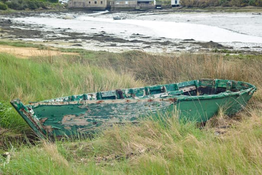 Green abandoned boat in the Atlantic Ocean