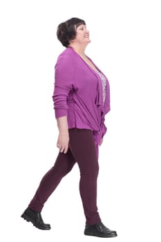 full-length.casual elderly woman in a purple blouse striding forward. isolated on a white background.