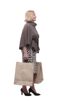 attractive mature woman with shopping bags . isolated on a white background.