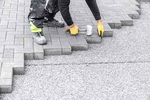 laying interlocking pavers during the construction of sidewalks and roads.