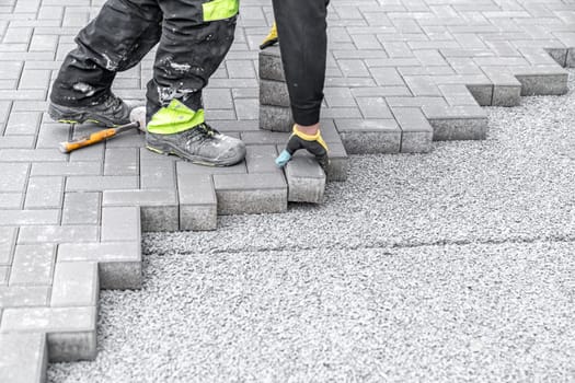 laying interlocking pavers during the construction of sidewalks and roads.