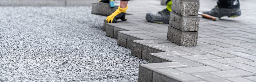 laying interlocking pavers during the construction of sidewalks and roads.