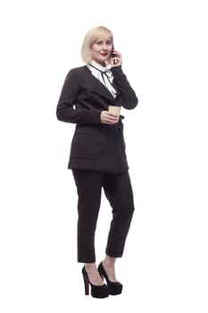 in full growth. business woman with a smartphone and takeaway coffee. isolated on a white background.