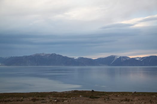 View of mountains across the bay from the community of Pond Inlet in the Baffin Region of the territory of Nunavut, Canada