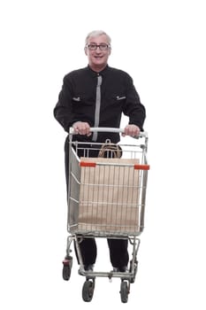 in full growth. happy old man with a shopping cart . isolated on a white background.