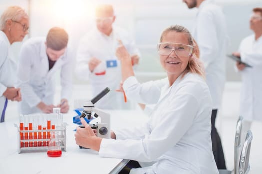 close up. senior female scientist sitting at a laboratory table. photo with a copy-space.