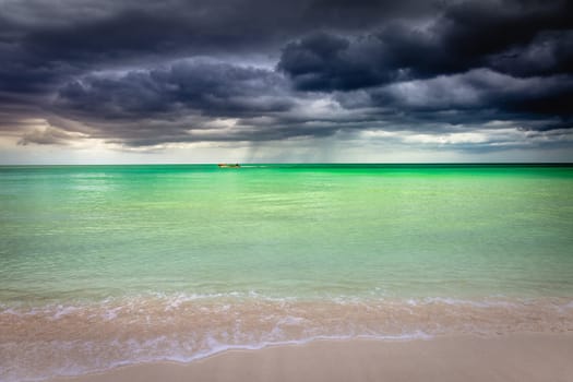 Tropical caribbean beach with storm clouds in idyllic Montego Bay, Jamaica