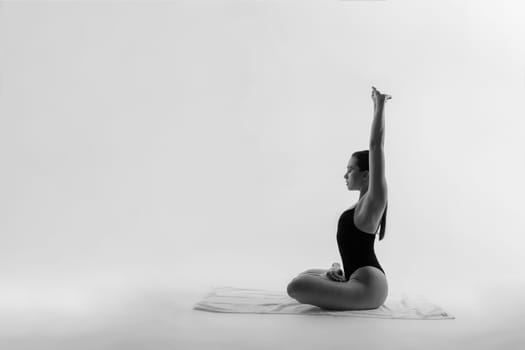 Athletic woman in swimsuit, doing yoga, push-ups, beautiful female exercising at a studio