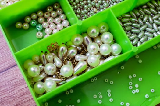 Colorful beads in containers close up, handicrafts, macrophoto