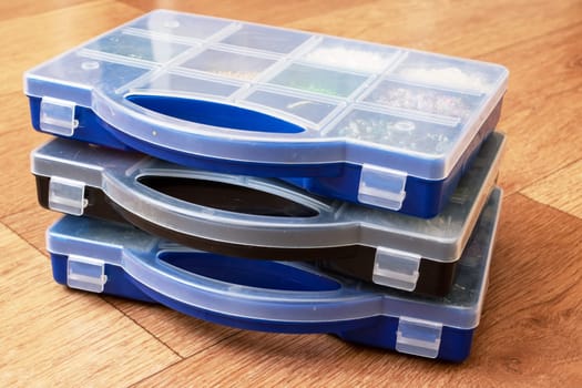 Small storage containers on a wooden floor close up