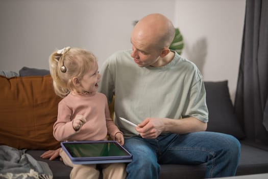 Deaf child girl with cochlear implant studying to hear sounds - recovery after cochlear Implant surgery and rehabilitation