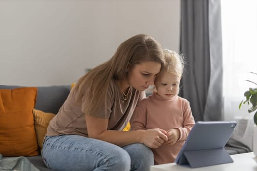 Deaf child girl with cochlear implant studying to hear sounds - recovery after cochlear Implant surgery and rehabilitation