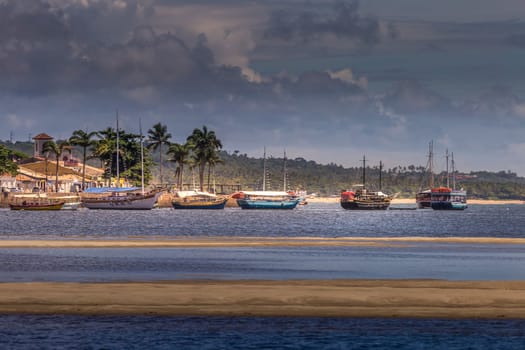 Idyllic Porto Seguro Beach at sunset with fishermen rustic wooden boats, BAHIA, Brazil