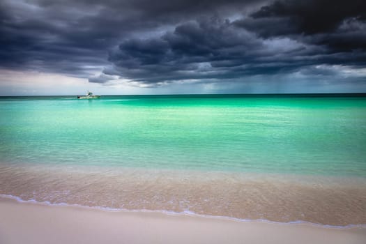 Tropical caribbean beach with storm clouds in idyllic Montego Bay, Jamaica