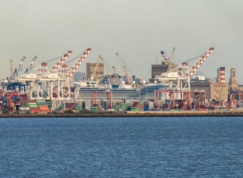 Buenos Aires, Argentina - 6 February 2023: Freight container cranes surround cruise ship in port