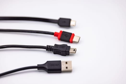 USB Type A and Type C as well as Micro USB and Mini USB connector cropped against white background with selective focus