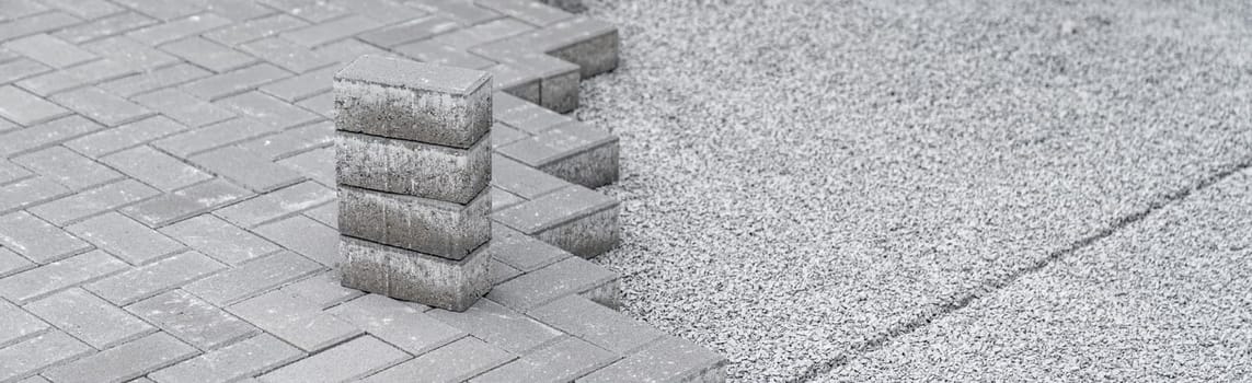 building a sidewalk, laying interlocking pavers.