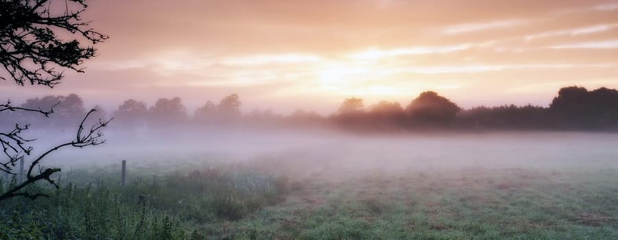 Misty sunrise over the farm. An picturesque farm scene covered in early morning mist
