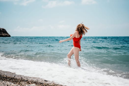 Pretty young blonde woman walking on the beach in summer, having fun, walks carefree on the seaside . Portrait beautiful young woman relax smile around beach sea ocean in holiday vacation travel trip.